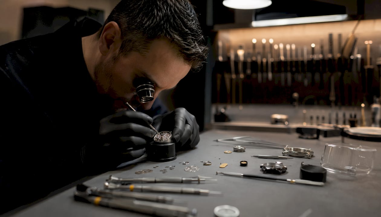 Watchmaker assembling ultra thin watch parts