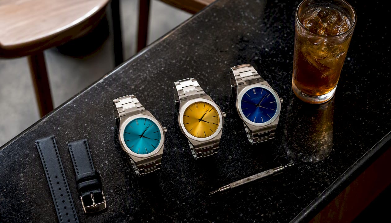 Wristwatches with fumé gradient dials on oak table