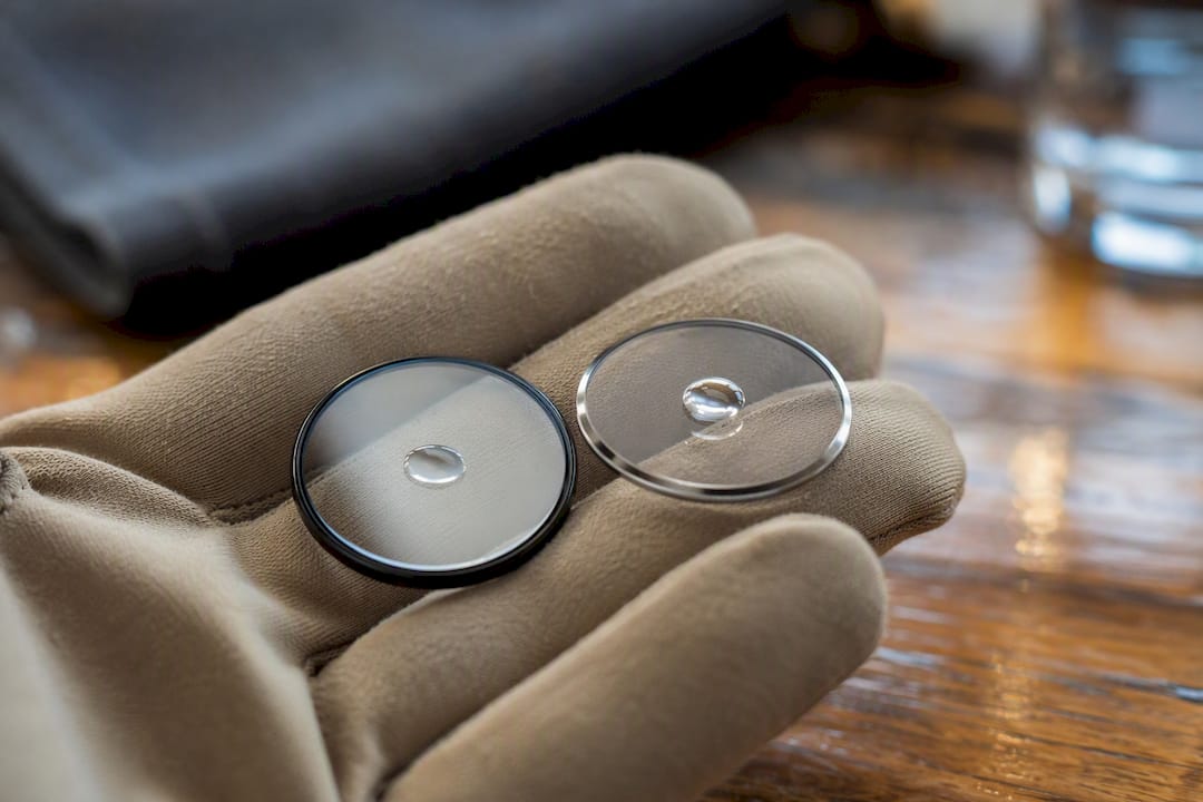 Water droplet beading on watch crystal surface