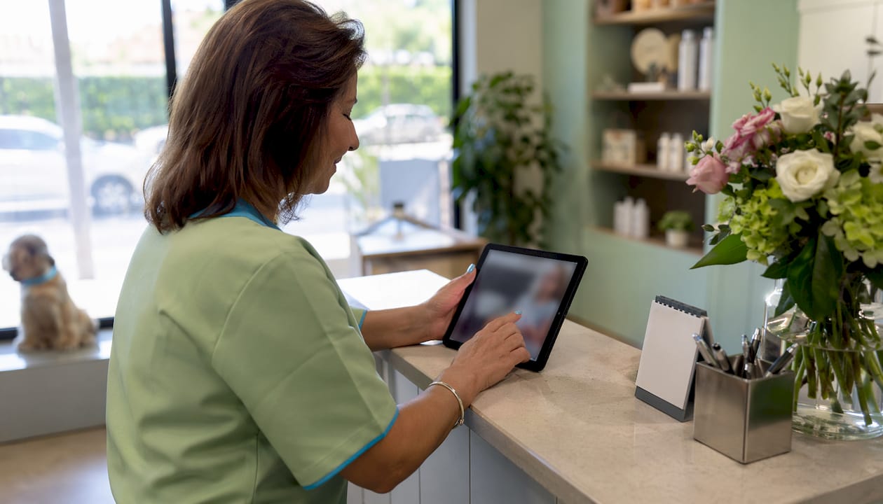 Hands using tablet for online booking automation