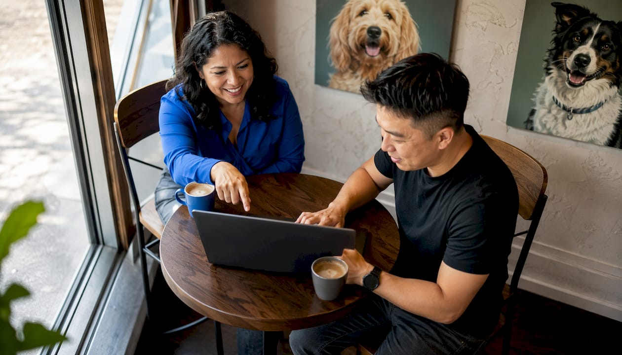 Two professionals collaborating on pet care software