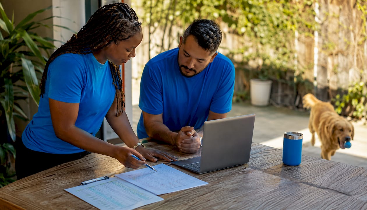 Two pet care employees discussing schedules