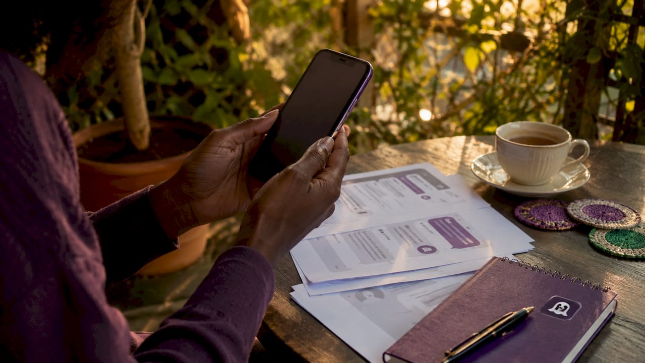 Overhead view of hands reviewing dating message screenshots