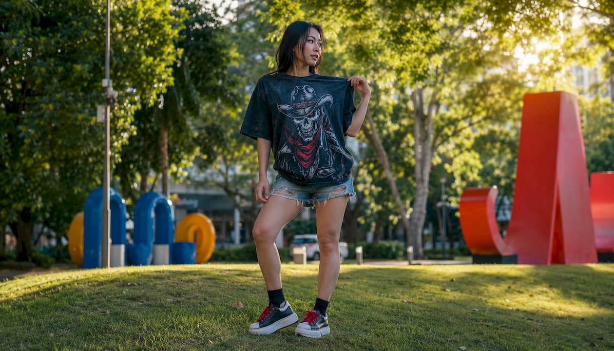 Woman wearing oversized outlaw graphic t-shirt outdoors