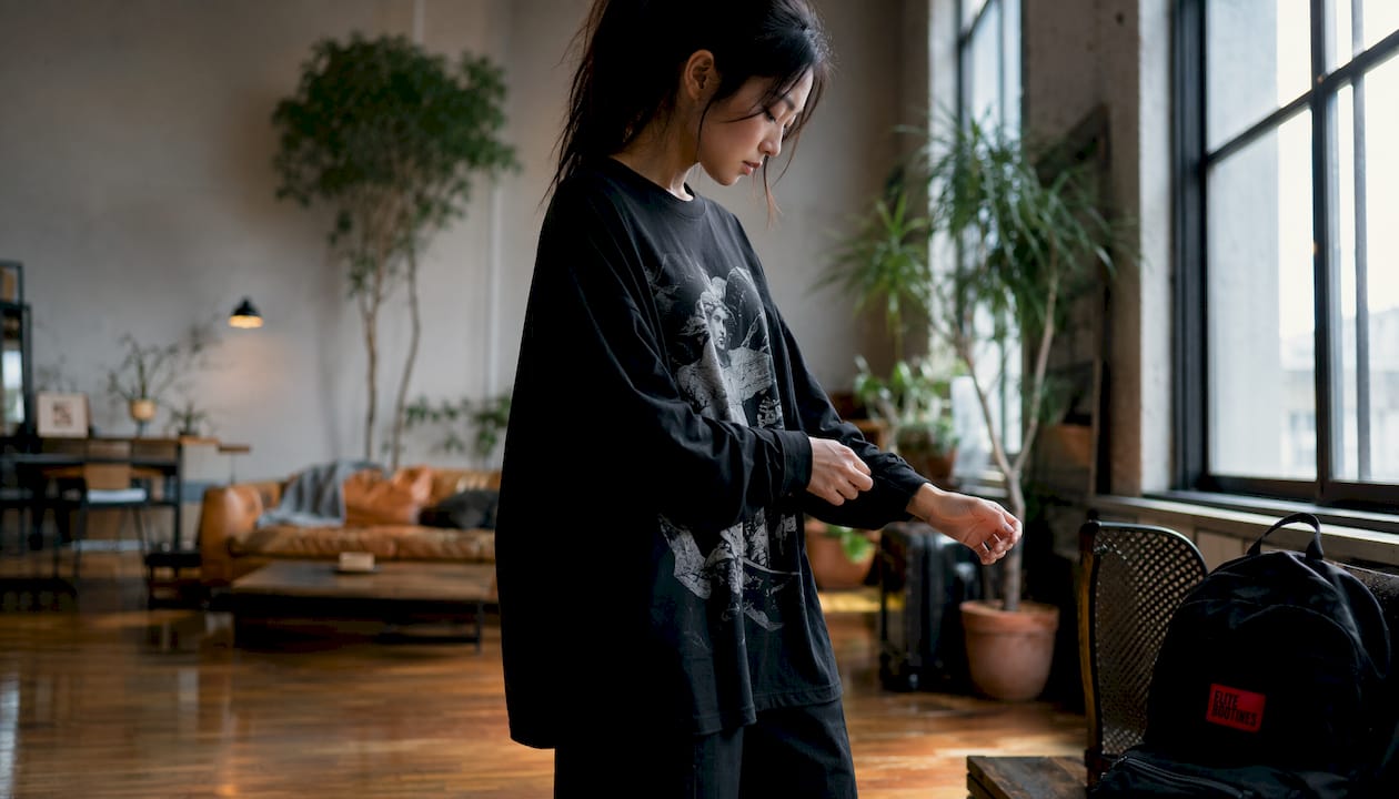Woman adjusting oversized streetwear shirt cuff