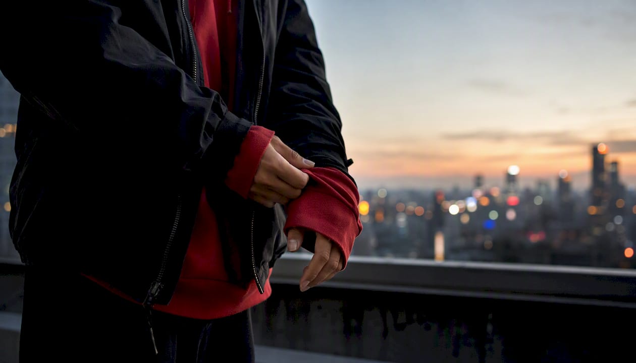 Side view of hoodie layered under jacket in streetwear style