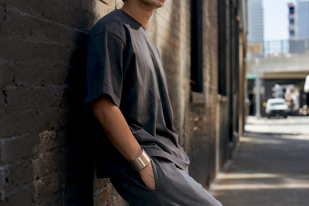 Stylish man in olive tonal oversized streetwear with bold chain