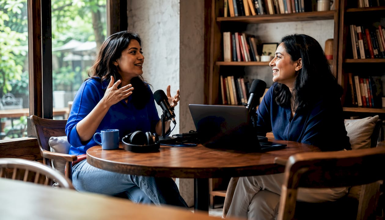 Two women recording a podcast conversation in studio