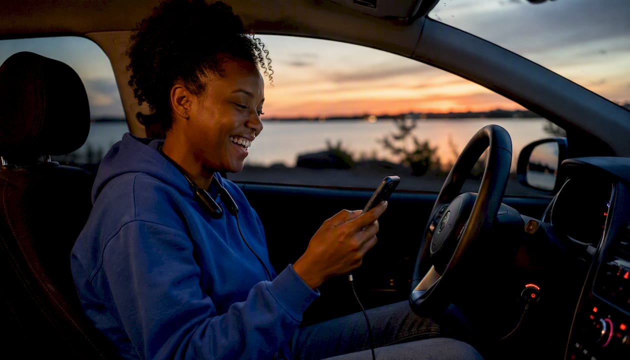 Woman laughs while listening to comedy podcast