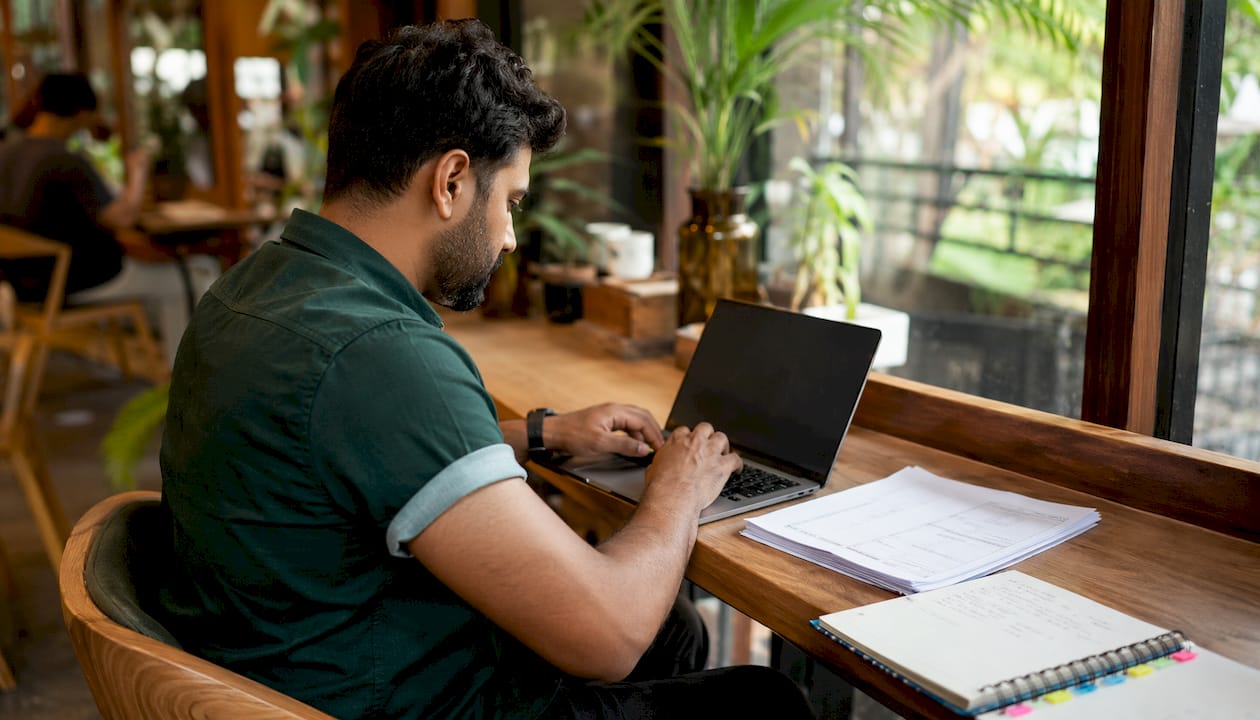 Hands typing supplier bank details verification