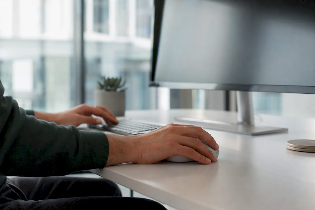Hands working at corporate desk with keyboard
