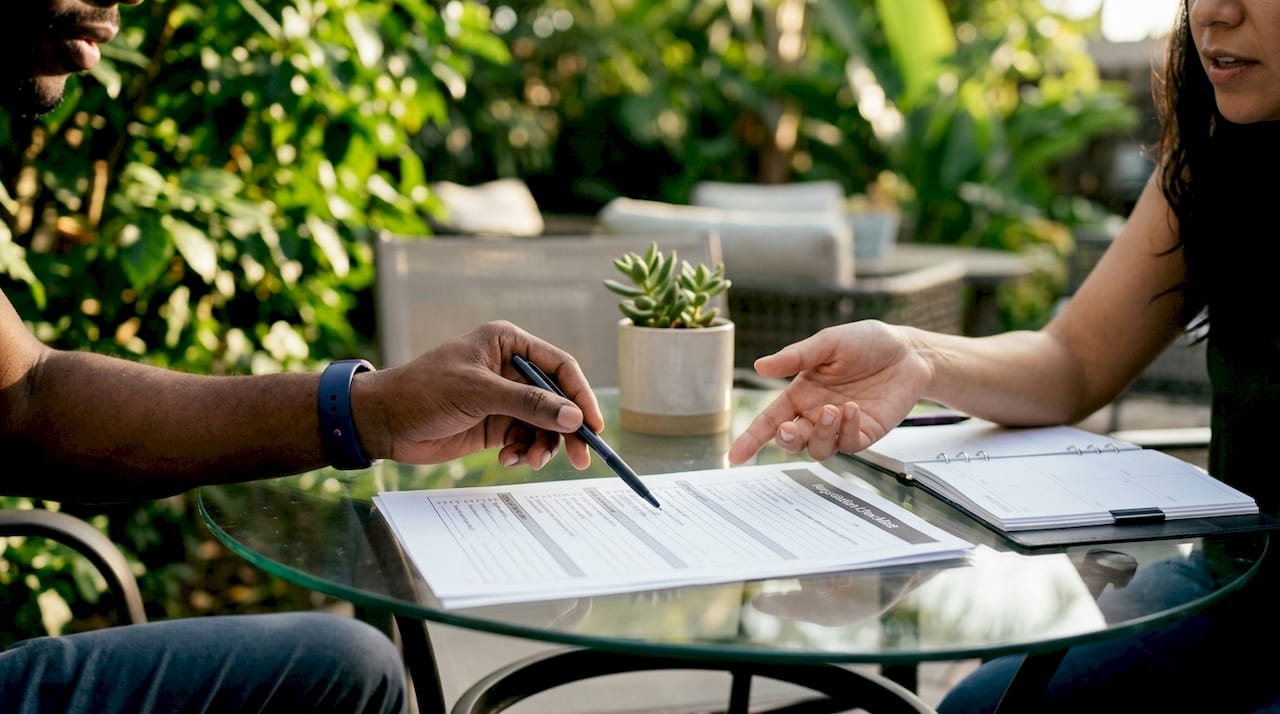 Hands collaborating on creditor negotiation checklist