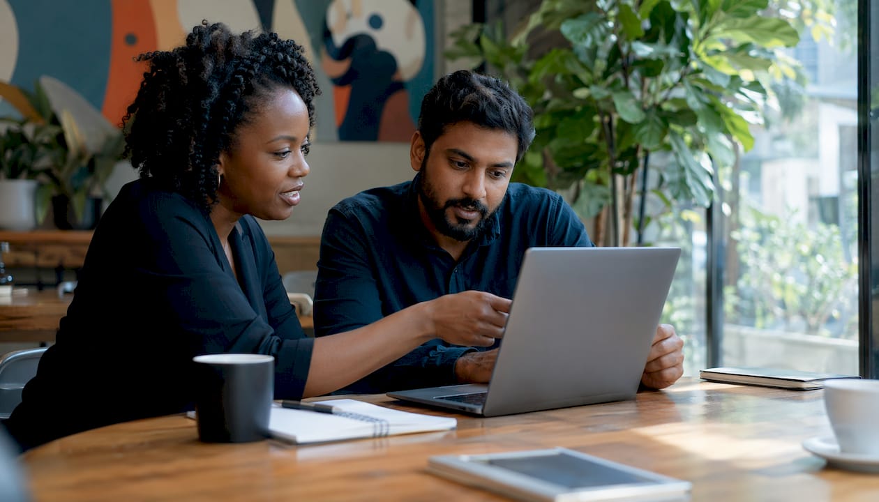 Two IT specialists discussing cloud market share data