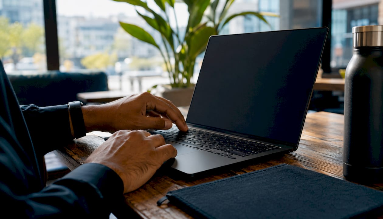 Hands typing on laptop in home cloud management