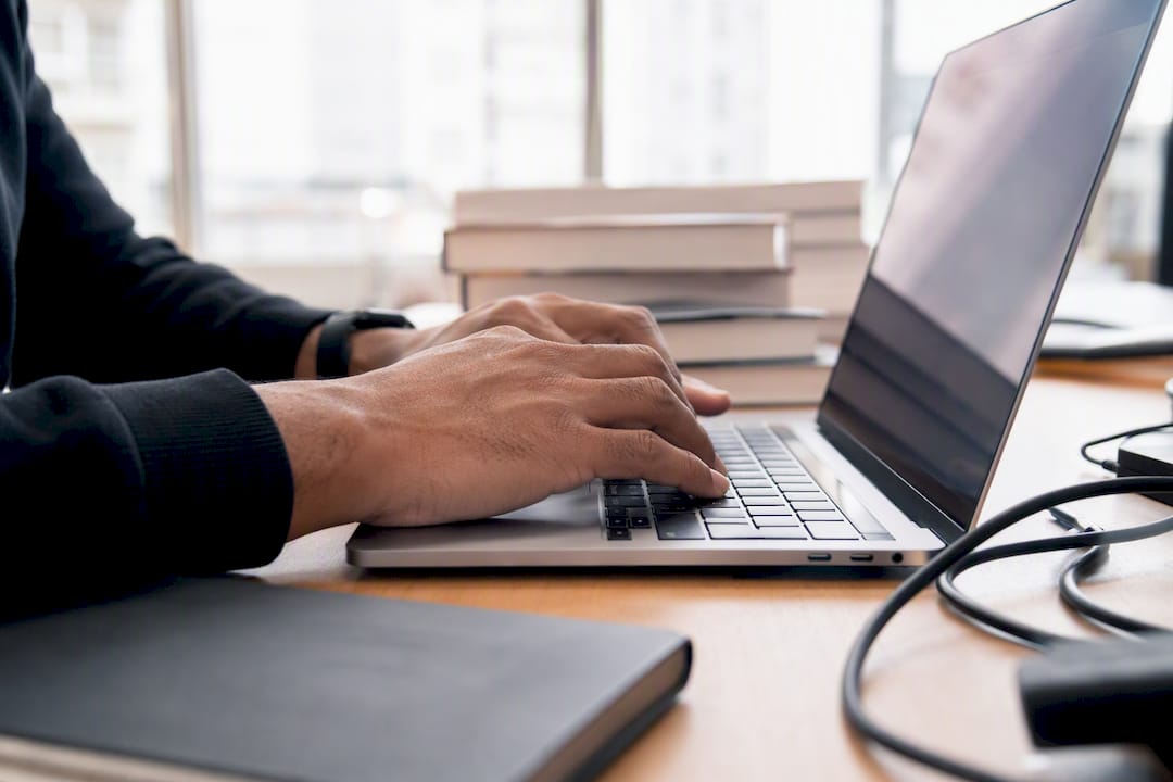 Hands typing PowerShell commands for license data