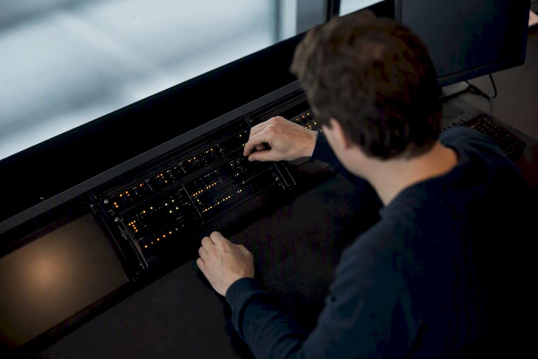 Hands adjusting digital monitoring device dials