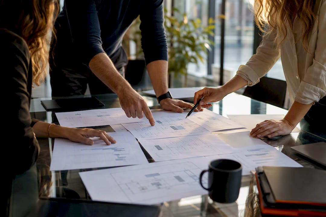 Hands arranging service and financial plans at MSP office table