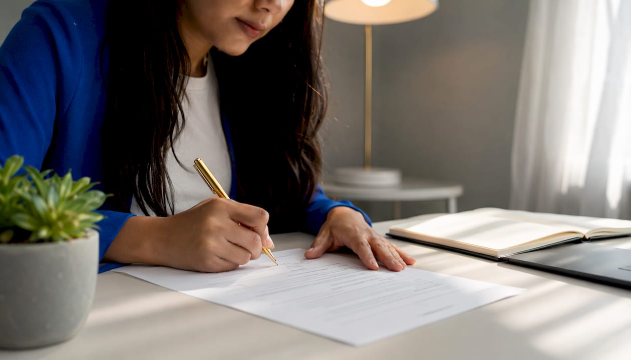 Hands customizing NDA contract at coworking desk