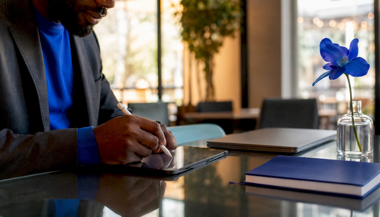 Hands signing contract on tablet