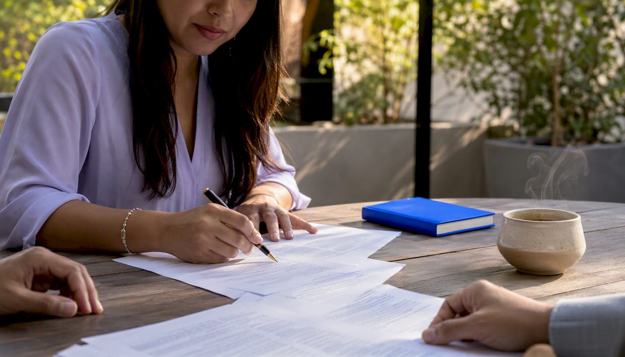Close-up of hands analyzing contract paperwork and timing