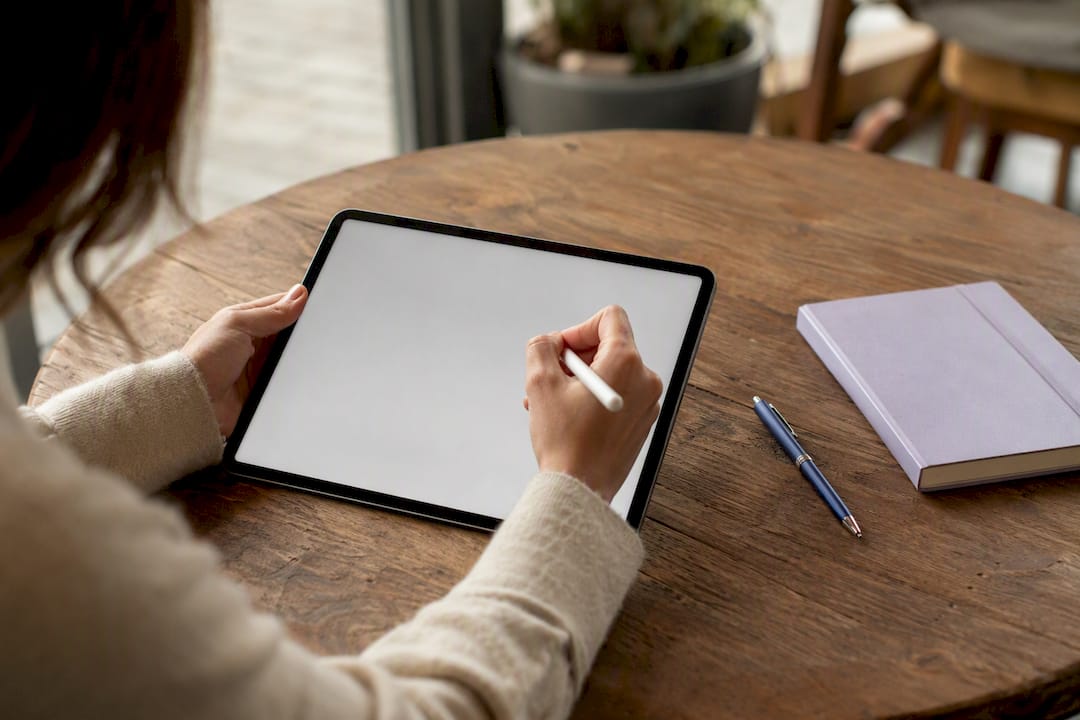 Hands drafting contract on tablet