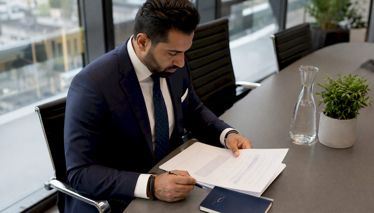 Hands reviewing cybersecurity audit papers