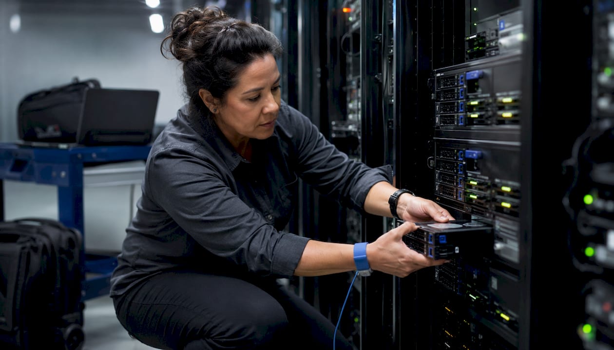 Technician installing drives in SAN array