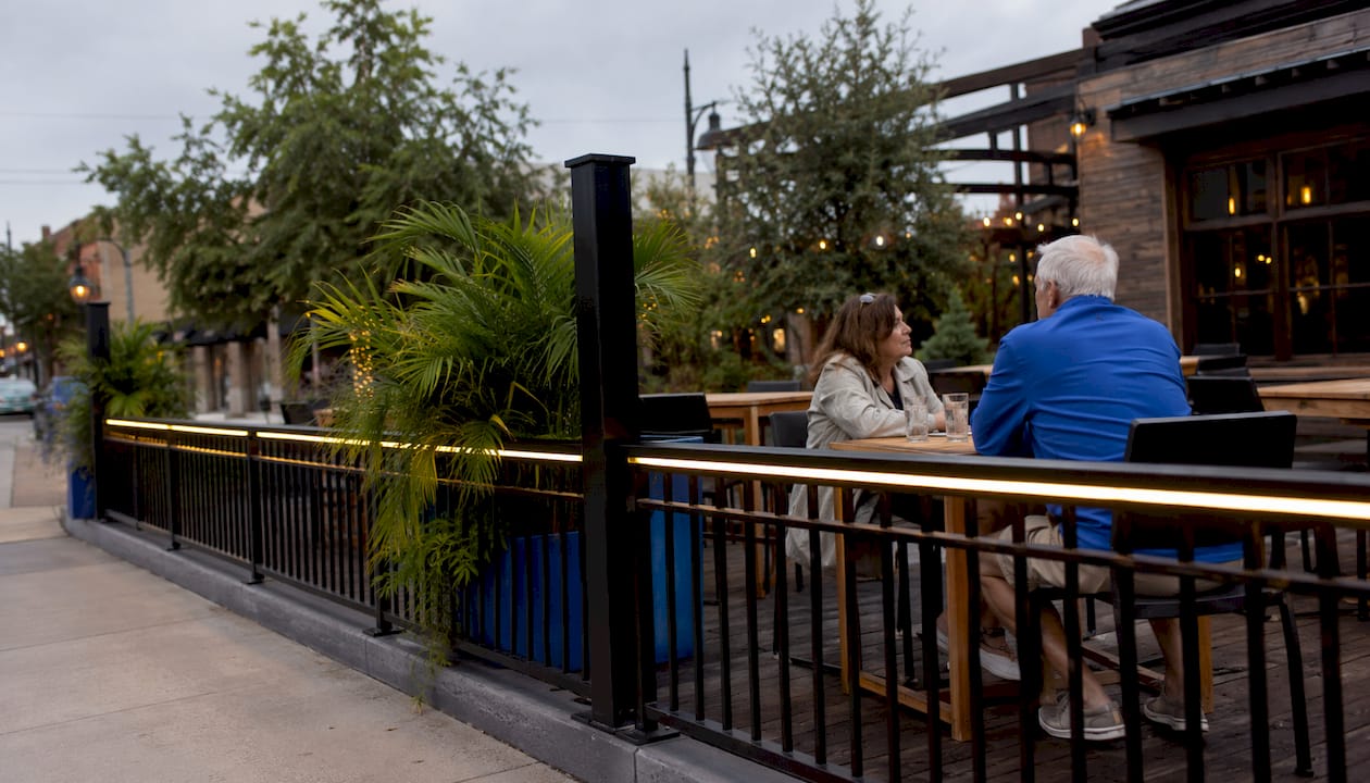 Coastal restaurant patio with illuminated fence