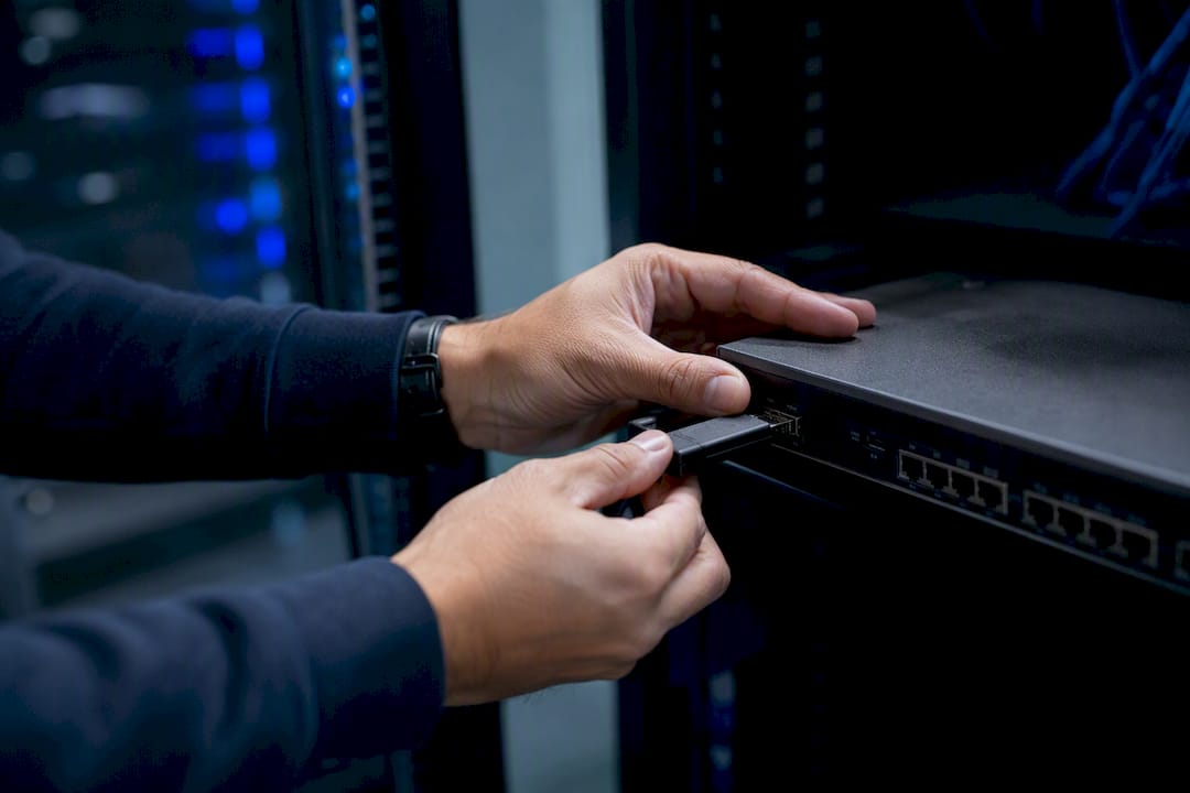 Hands inspecting hardware for security compliance