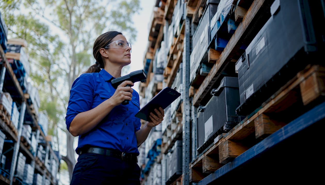 Technician scanning parts in warehouse inventory