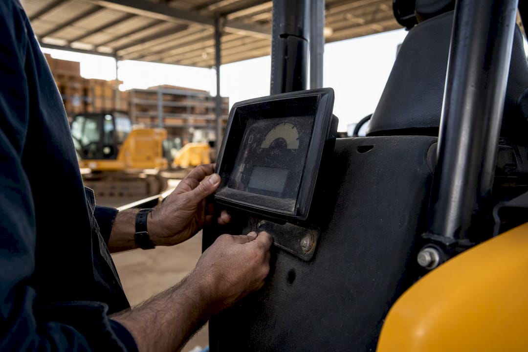 Technician hands inspecting vehicle odometer and VIN