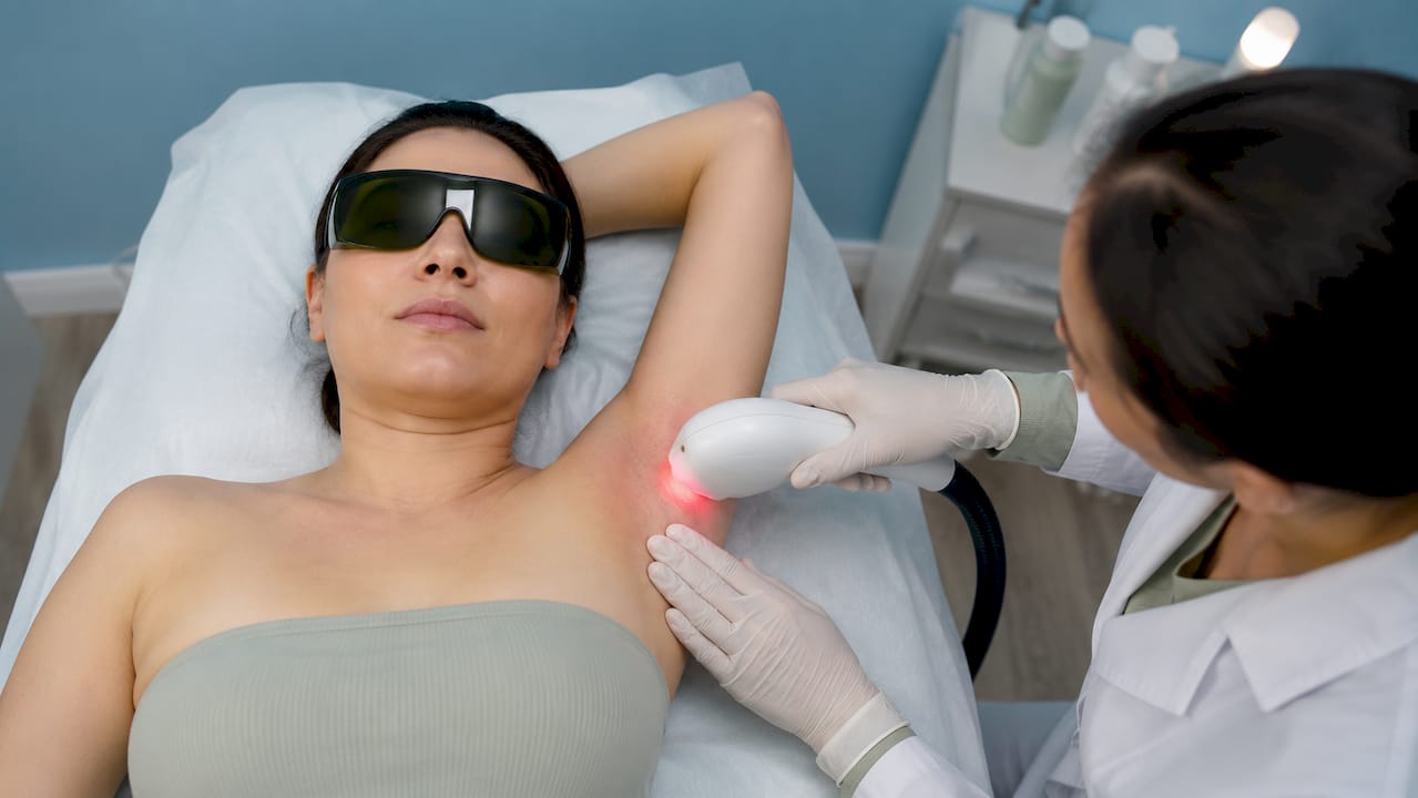 Close-up of laser device treating underarm skin