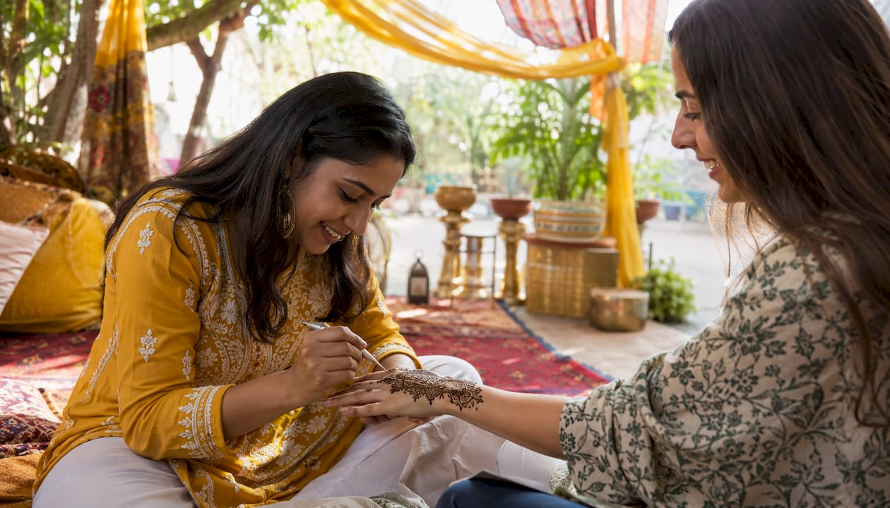 Woman applying henna at decorated event table