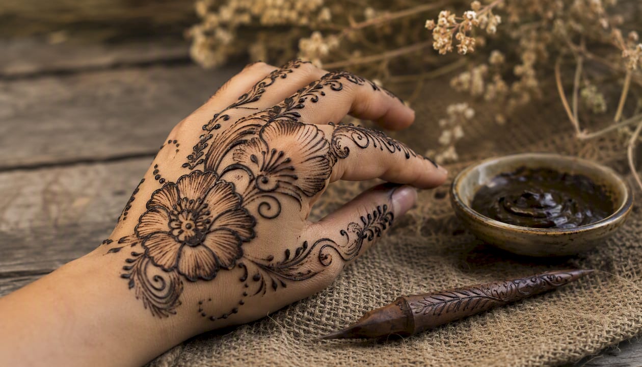 Hand with bold Arabic henna design
