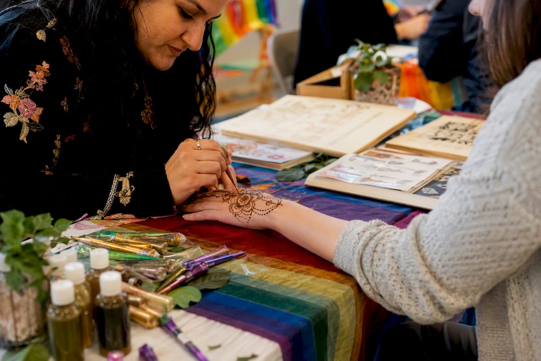 Henna booth setup at outdoor Pride event