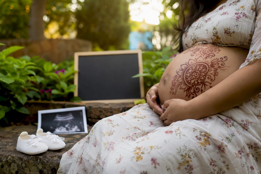 Maternity henna belly with meaningful baby props
