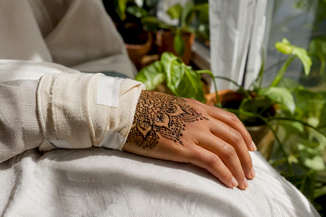 Hand with fresh henna paste wrapped