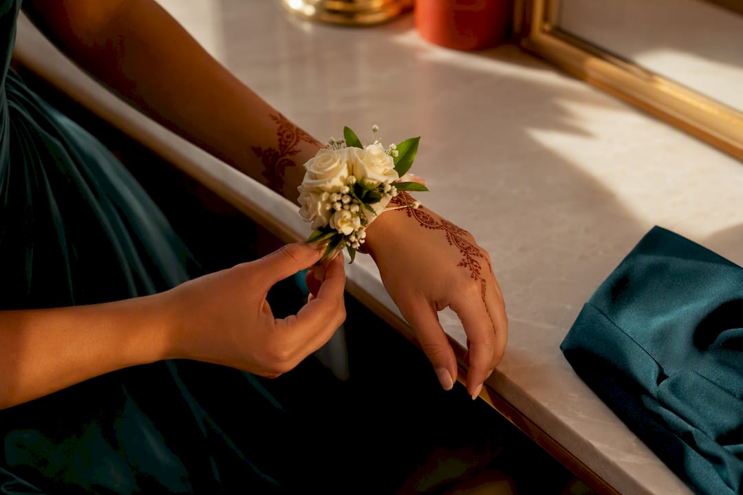 Henna framing a prom corsage on wrist