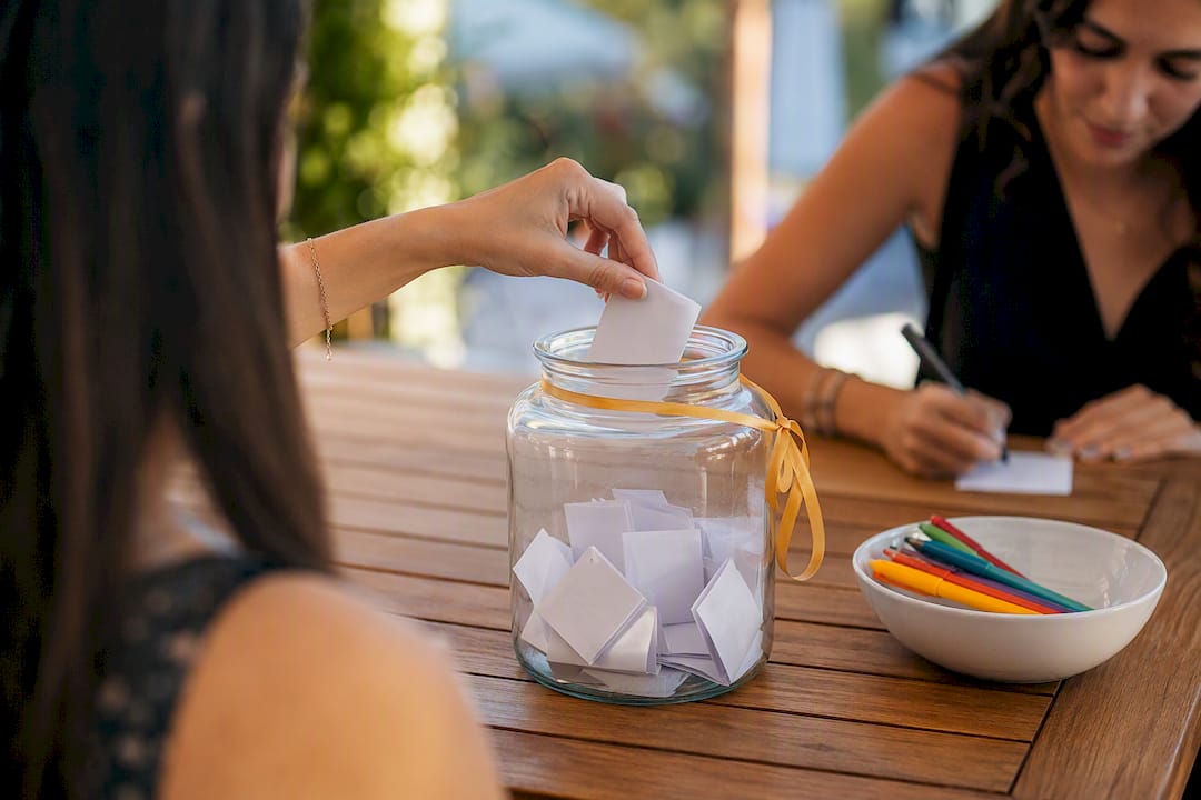 Guest adding advice note to keepsake jar