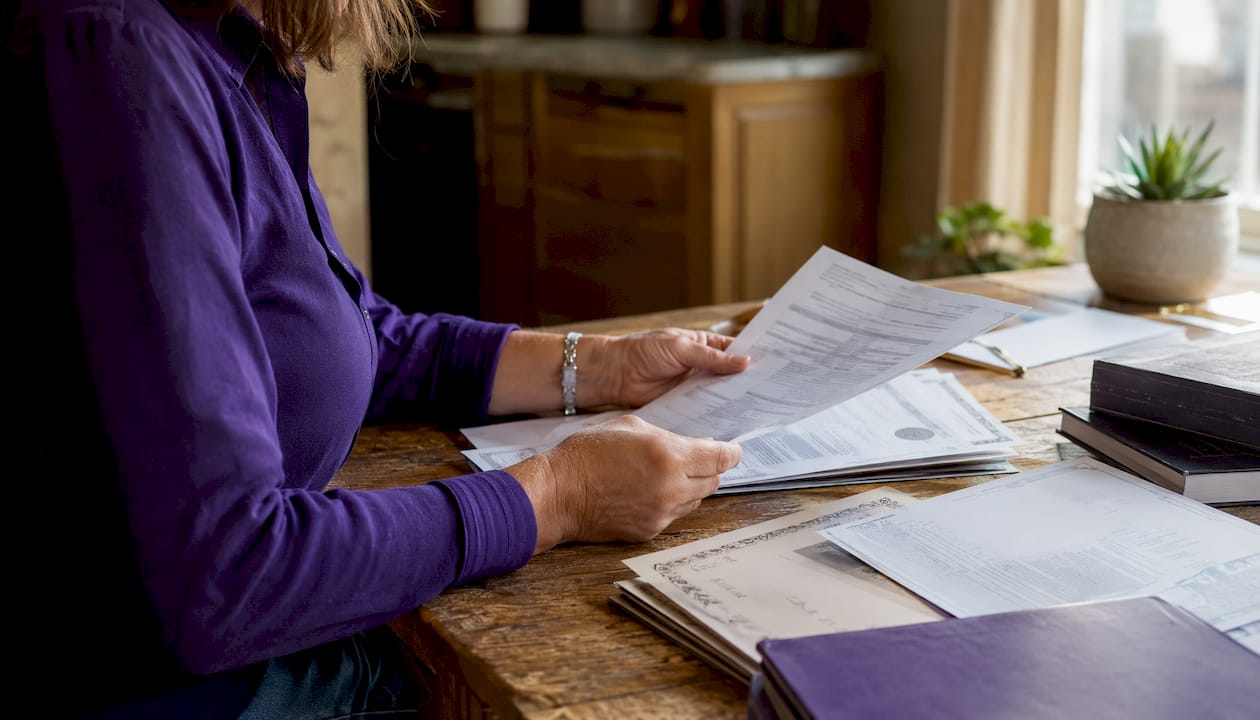 Hands holding tutor credentials and documents