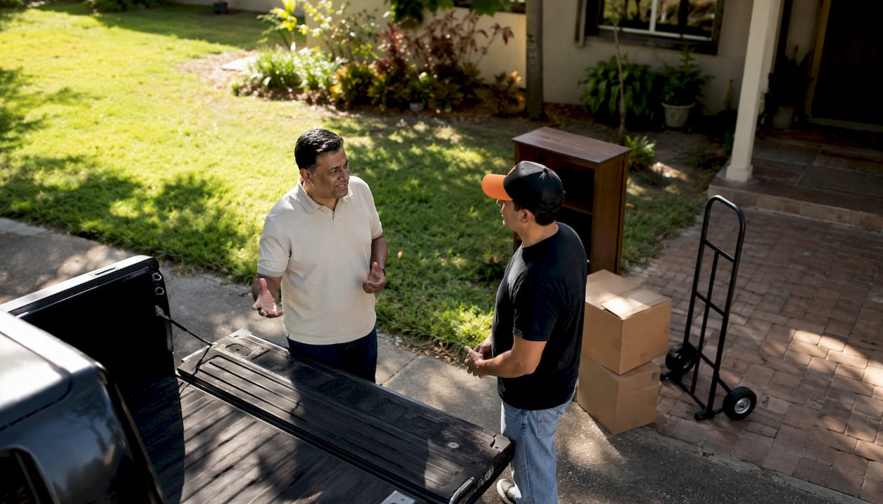 Customer and helper discussing hauling job outdoors