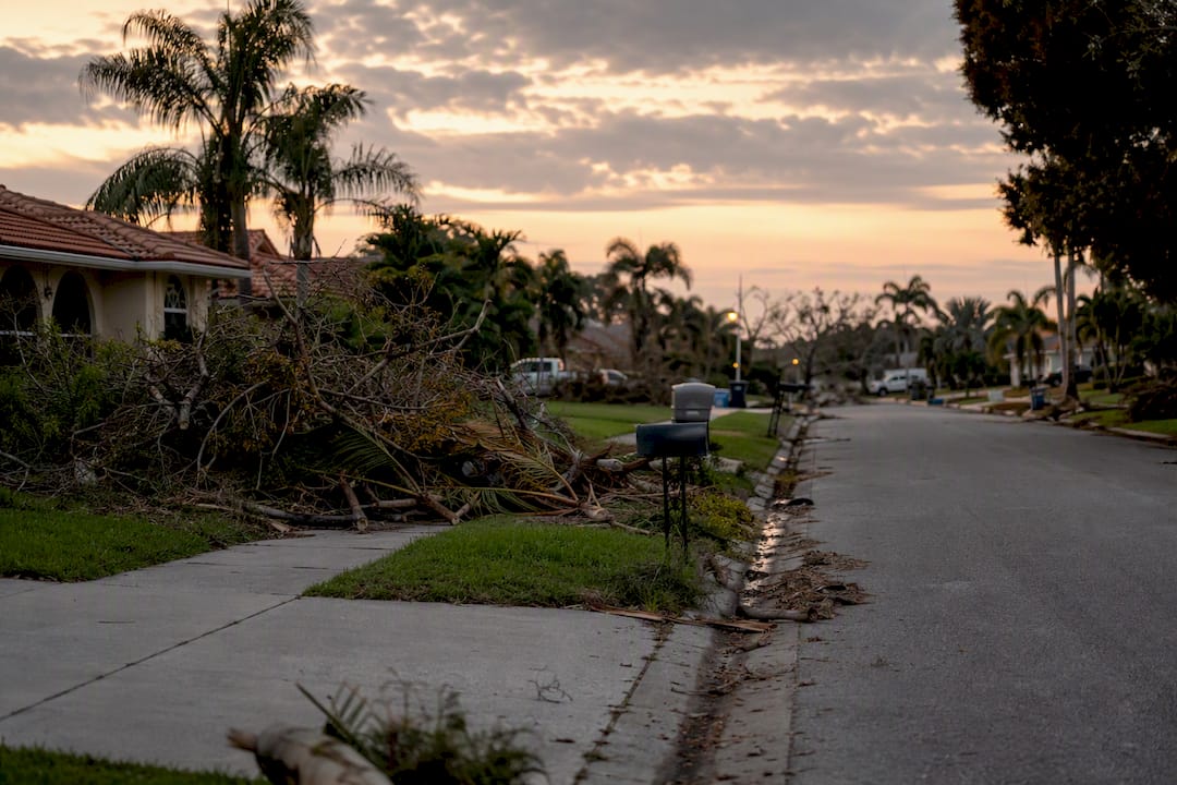 Street with leftover hurricane debris awaiting pickup