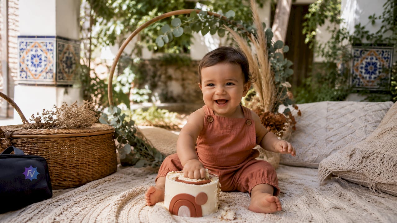 Sesión de fotos boho para bebés con tarta, en un estudio acogedor