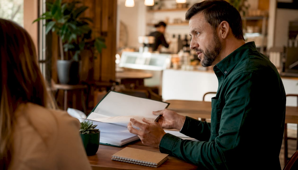 Small business owner considering AI marketing proposal