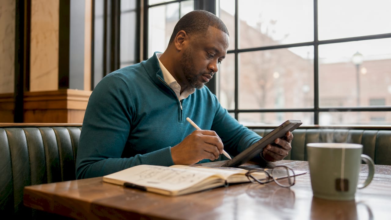 HR professional drafting role summary on tablet in office
