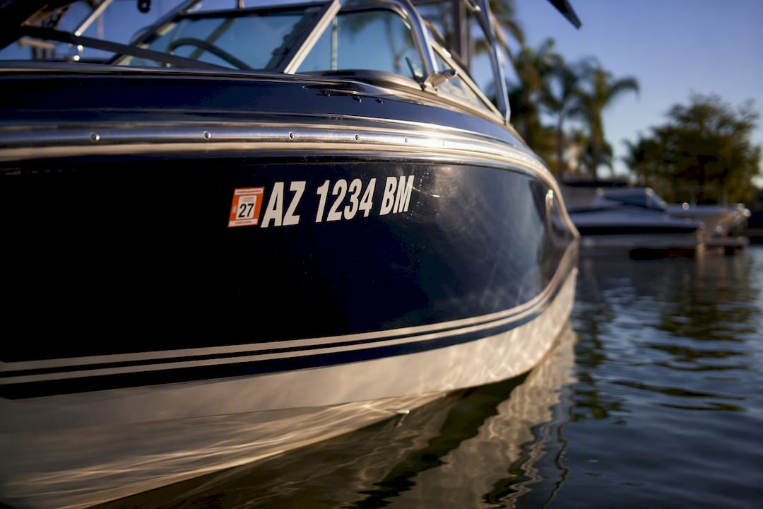 Boat hull with brackets holding legible registration numbers