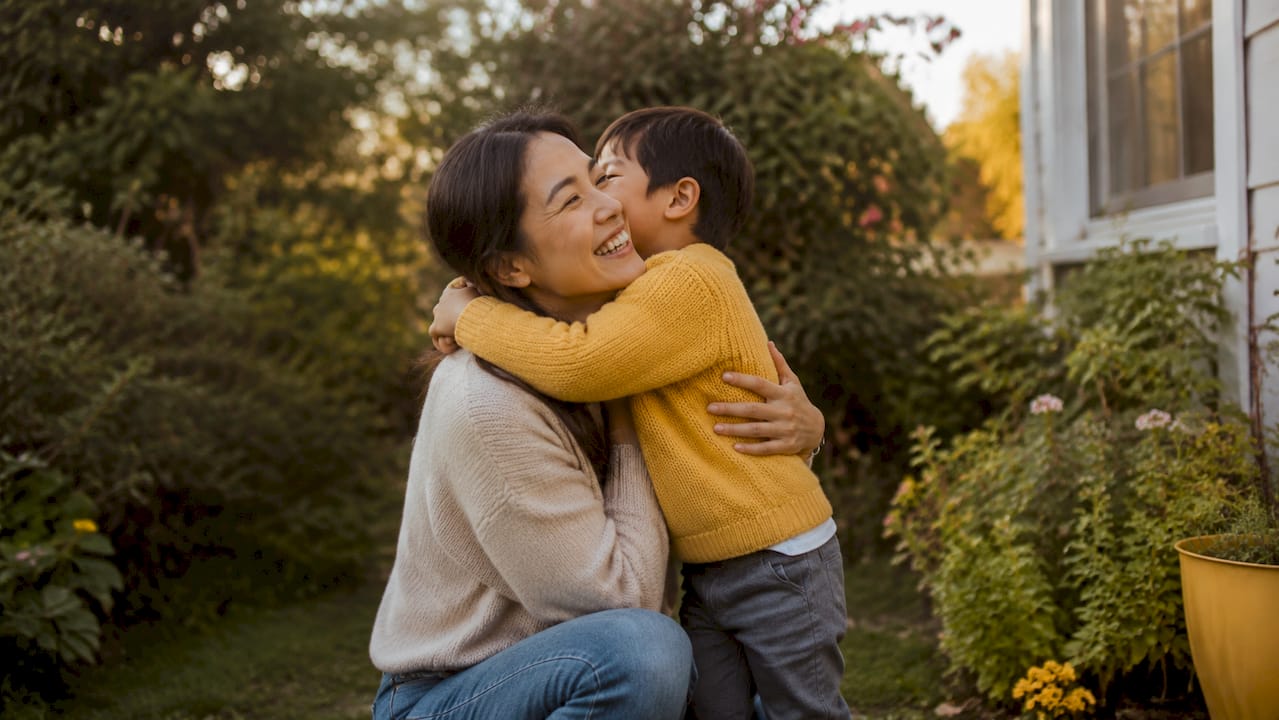 Child hugging parent in cozy living room