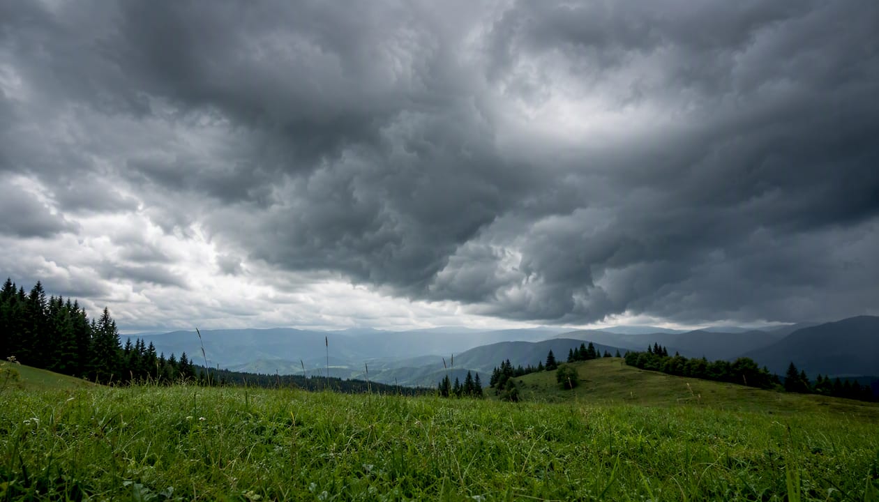 Heavy cumulus clouds over hills