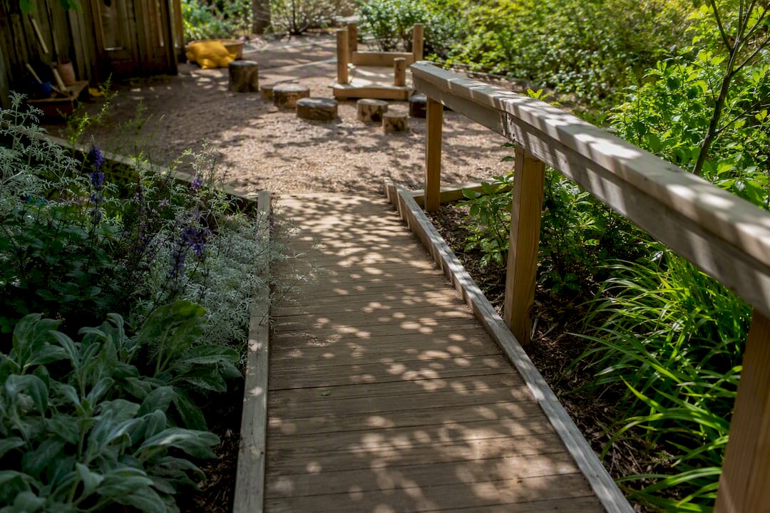 Wooden ramp and accessible sandbox in backyard