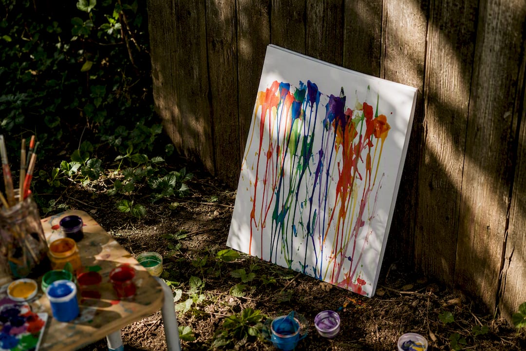 Wet toddler painting leaning to dry indoors